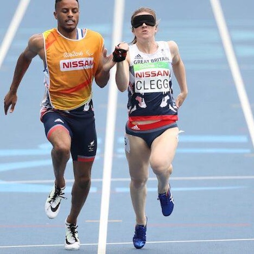 Libby-Clegg-in-Team-GB-kit-wearing-a-blindfold-and-with-her-running-guide