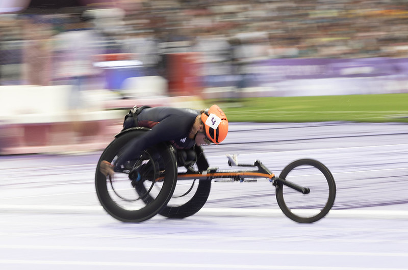 A view from the side of Eden racing in her wheelchair